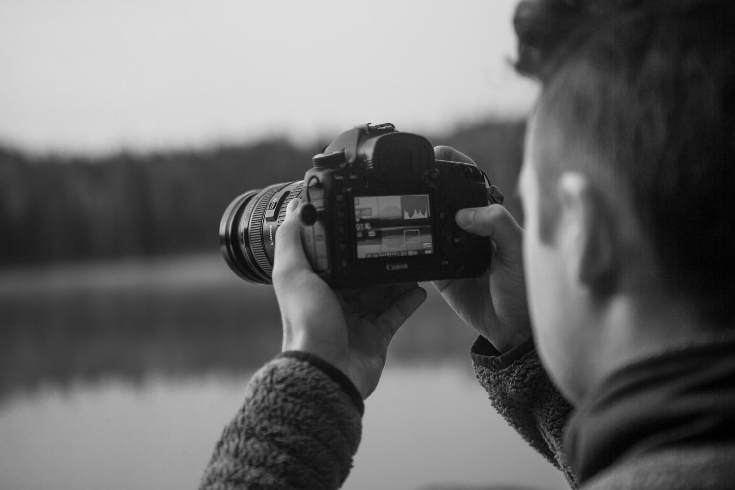 Photo of a male taking a photo with his Canon camera