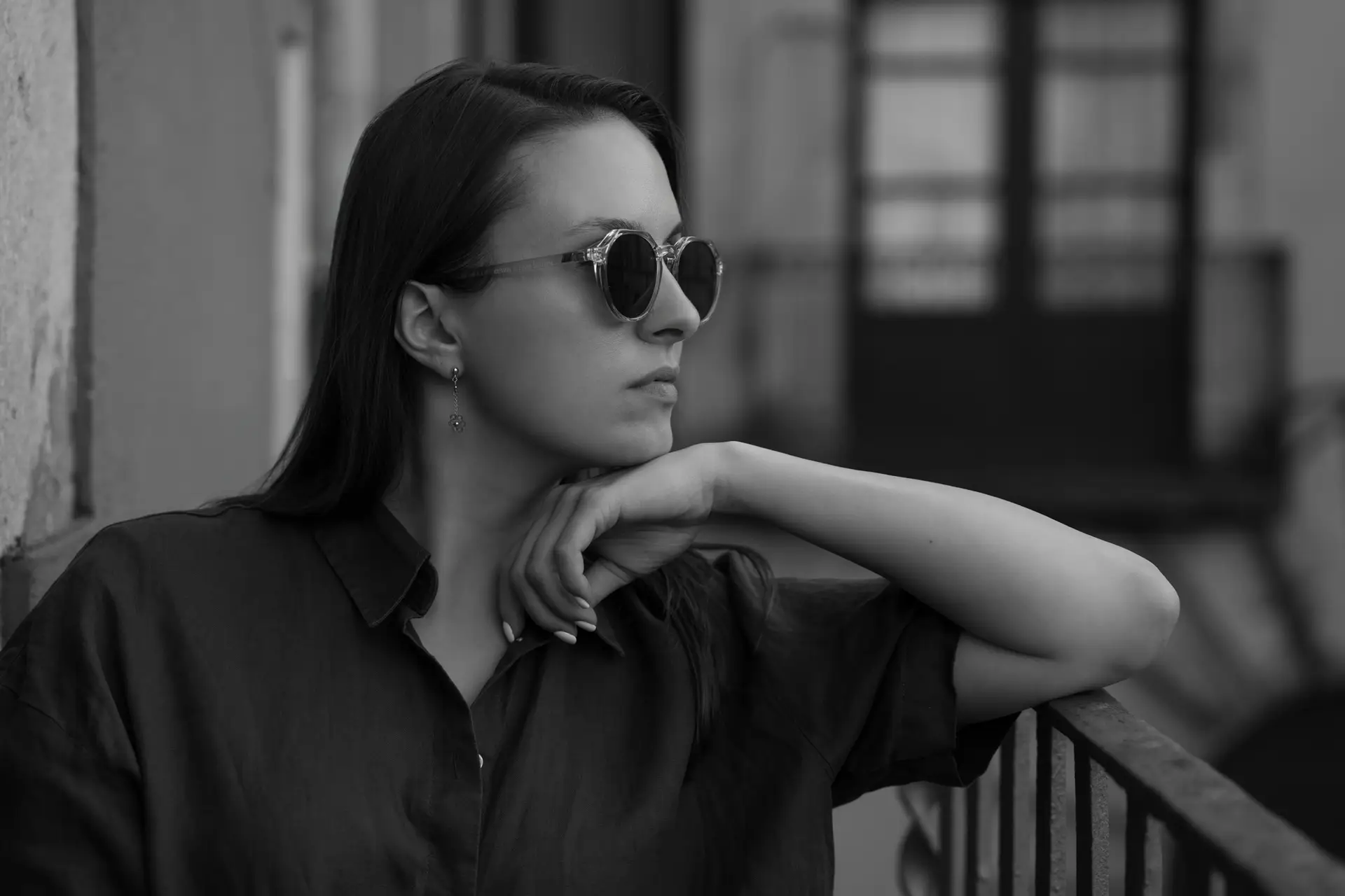 Black and white portrait photo of a young woman with a shallow depth of field and blurry background