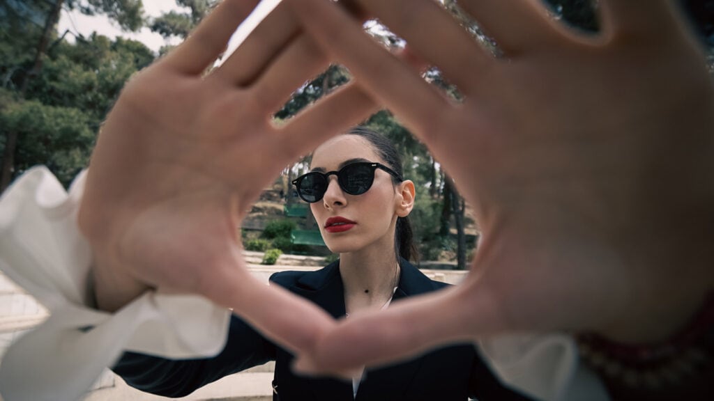 Portrait photo of a young woman wearing black sunglasses